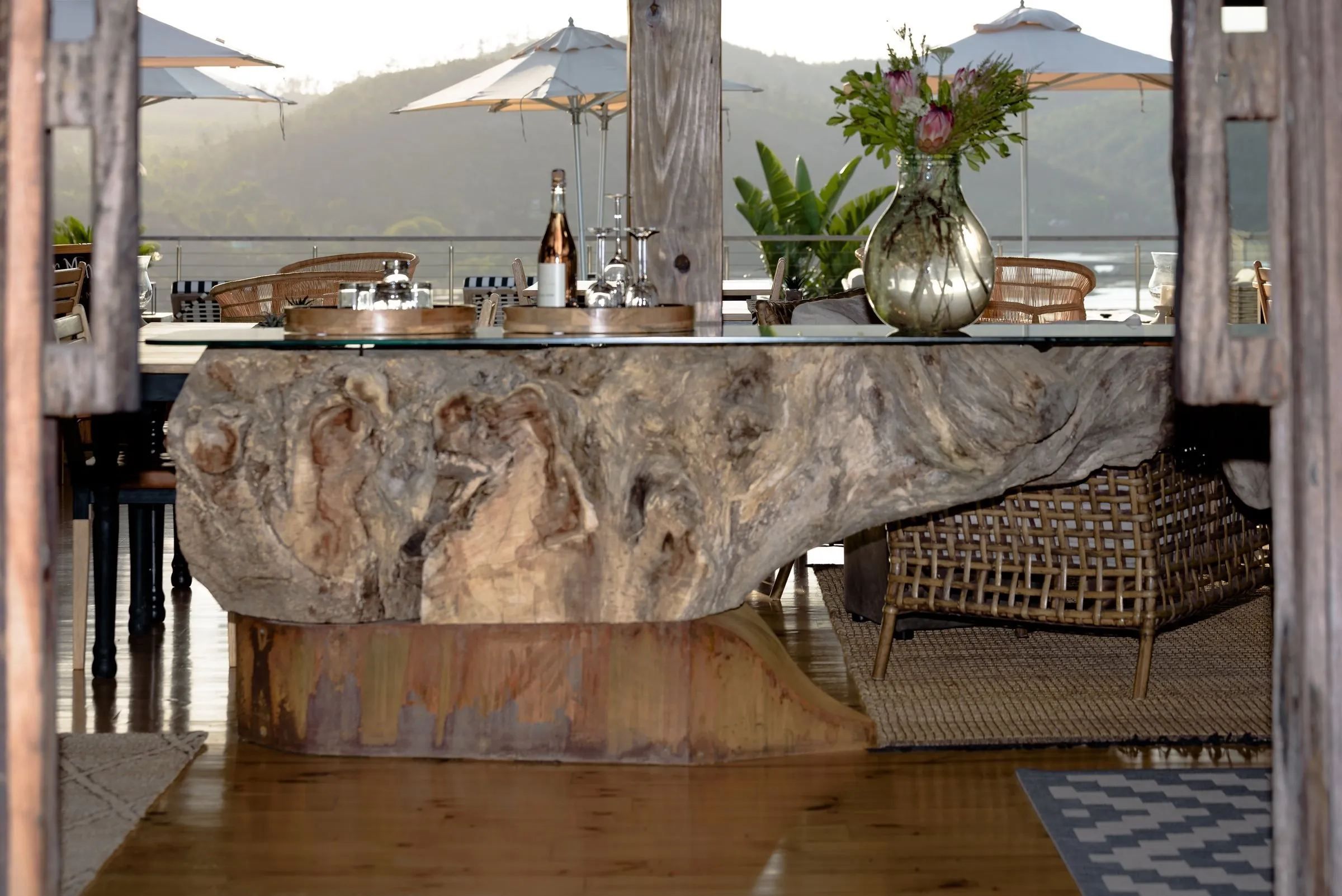 A driftwood table set on the deck, looking out over the Knysna Lagoon