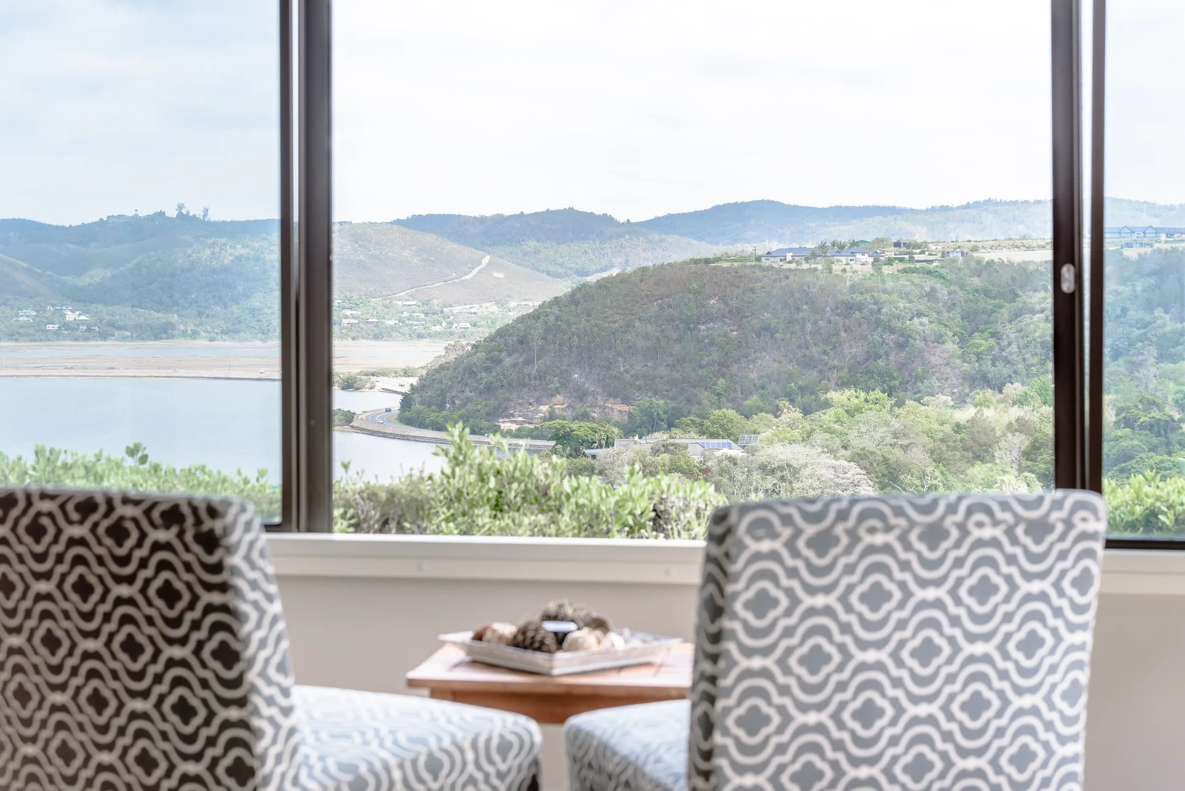 Sunroom chairs facing the Knysna Lagoon in the Bird’s Eye Suite