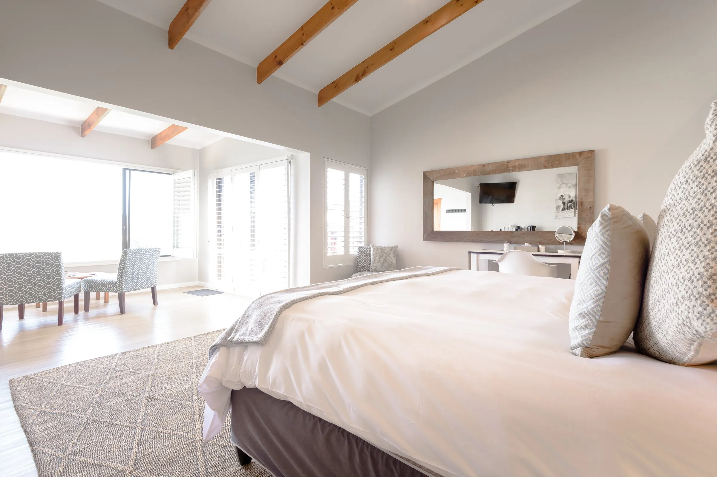 Bird’s Eye Suite bedroom opening onto a bright sunroom