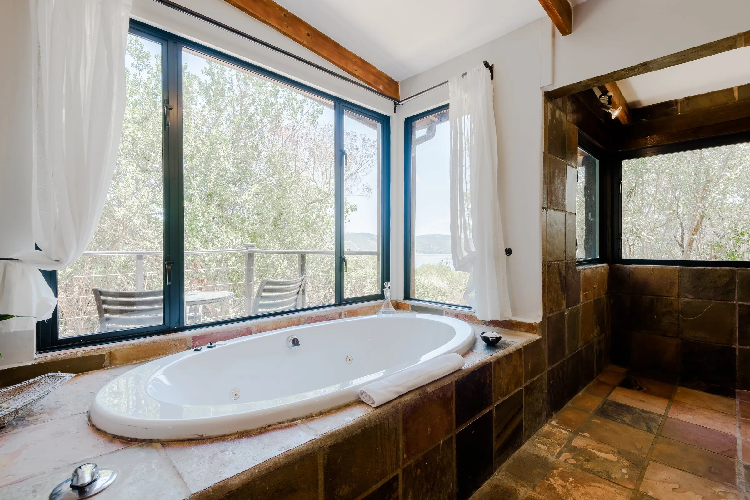 Spa bath under windows to the garden in the Fynbos Suite