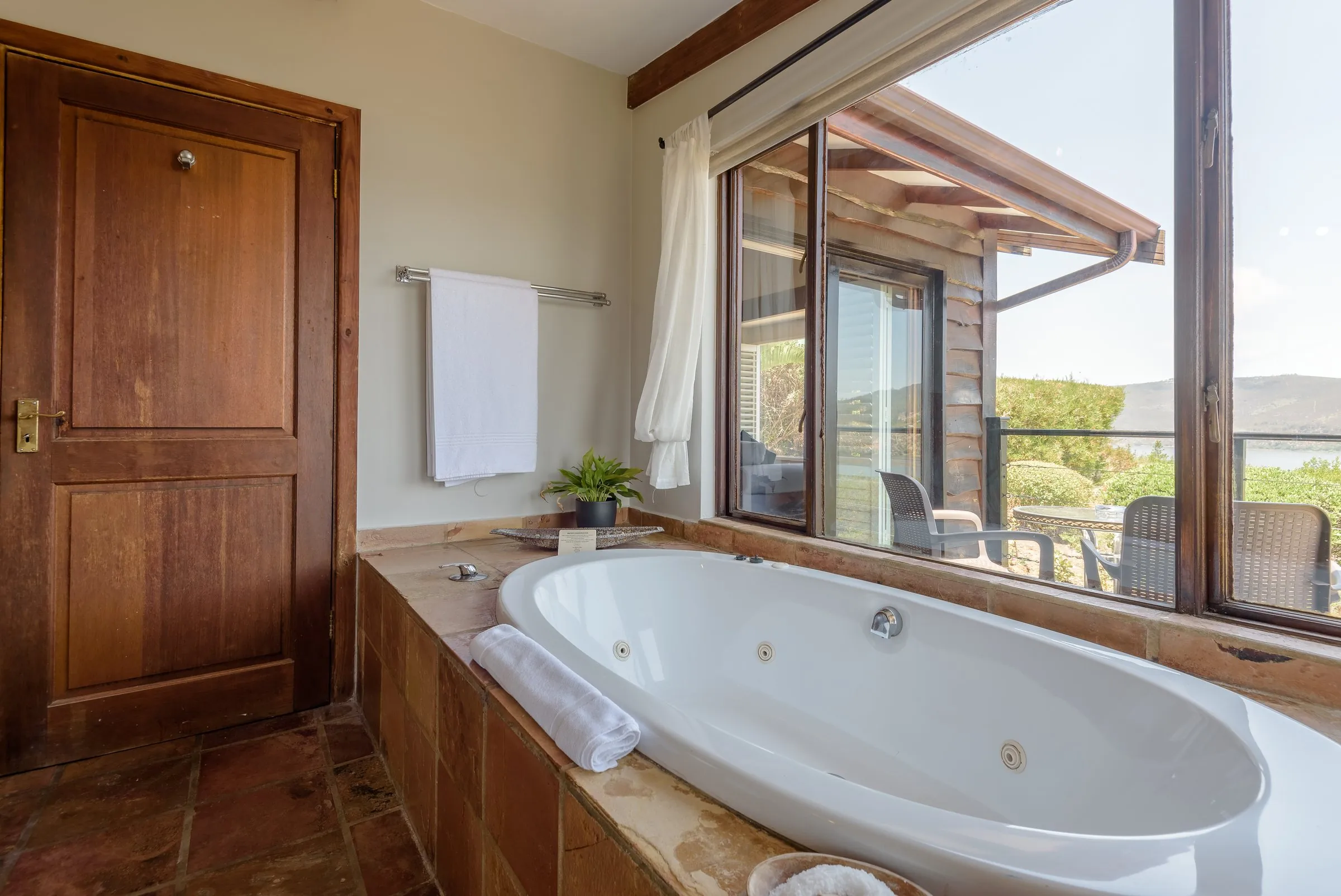 Spa bath set in stone tiles in the Lagoon Suite