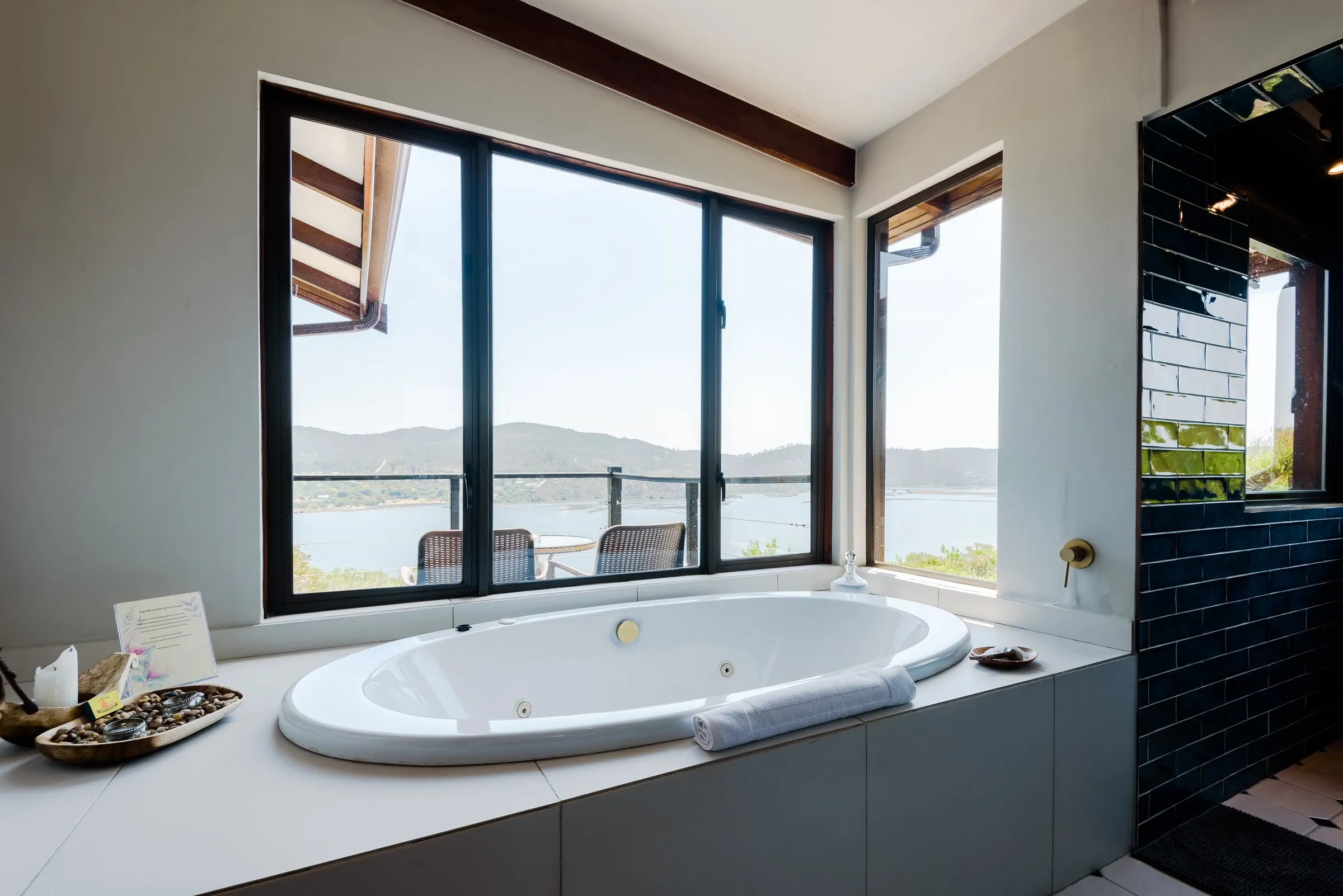 Spa bath beside a window in the Peregrine Suite