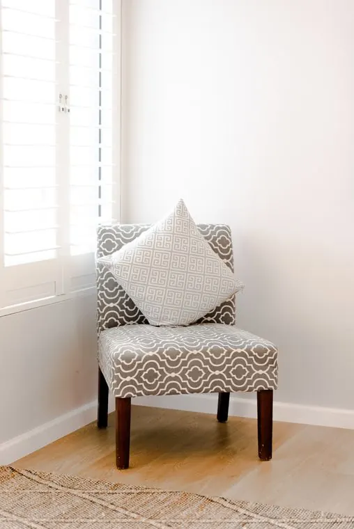 A patterned armchair in the corner