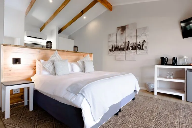 King-size bed with a timber headboard, and the refreshment station