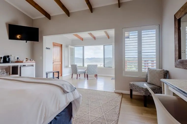 The bedroom opening into the bright sunroom