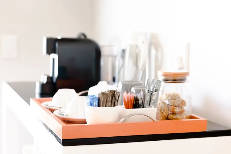 Coffee and tea on an orange tray