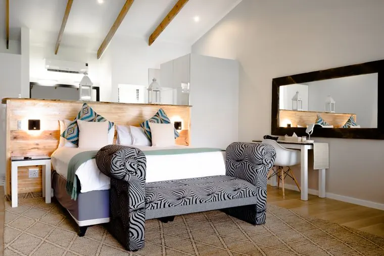 A zebra-print bench at the foot of the bed