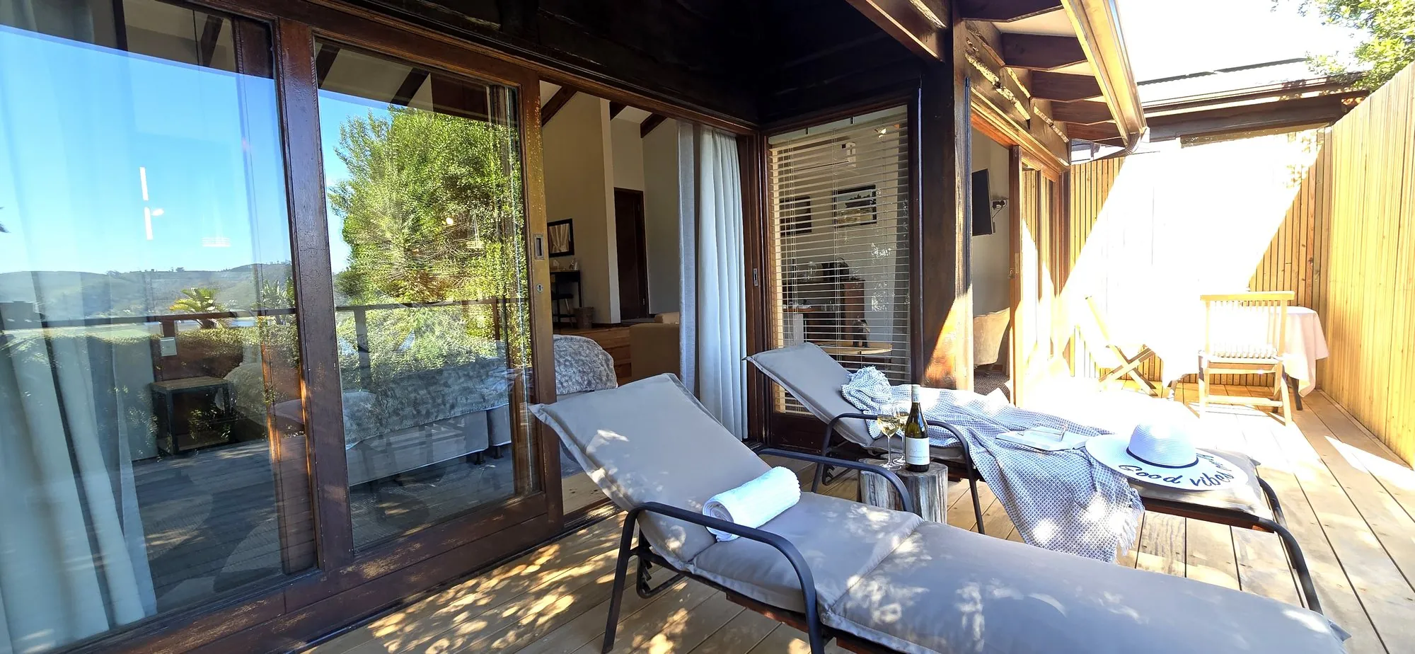 Sun loungers on the private deck beside the glass doors