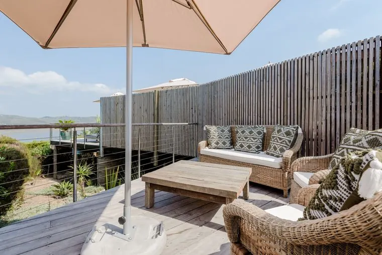 Lounge chairs and an umbrella on the wide wooden deck