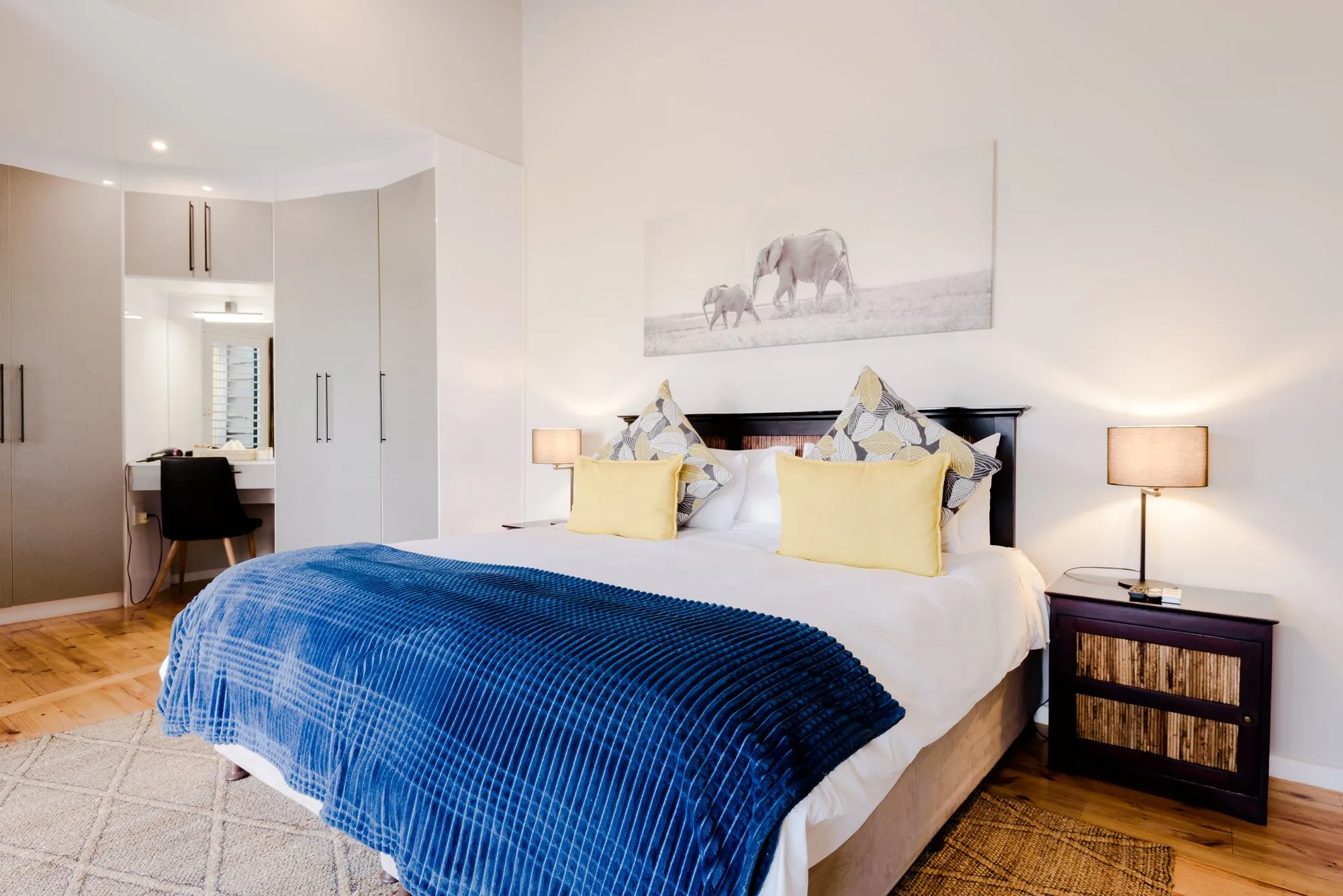 King-size bed with a blue throw in the main bedroom