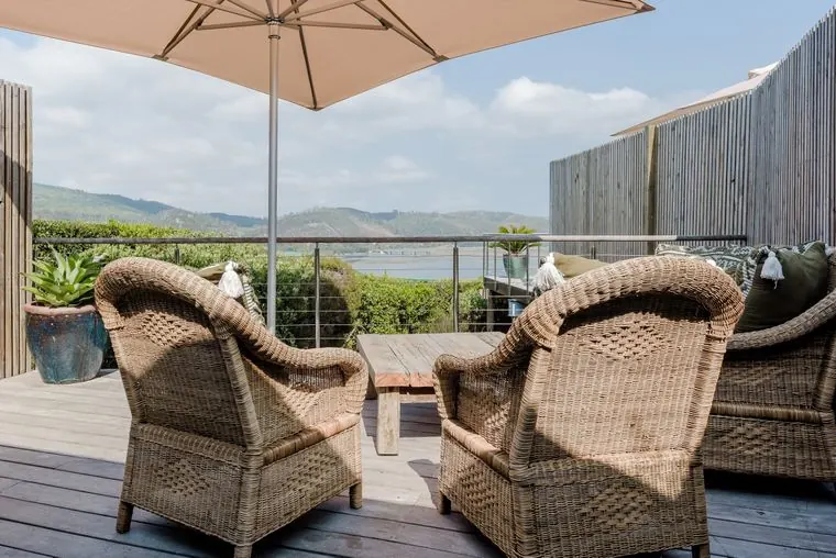 Wicker armchairs on the deck above the lagoon
