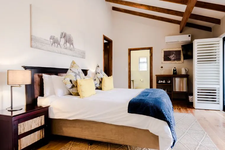 The bed, a reading lamp and the doors to the deck